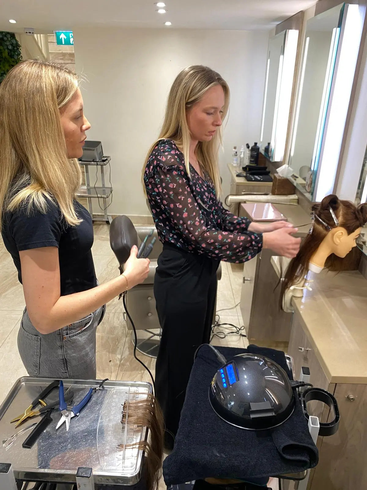 Gold Fever educator demonstrating hair extension application.